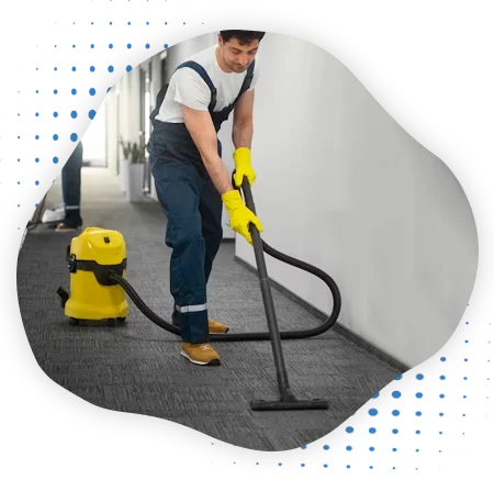 A Cleaner doing steam carpet cleaning by vacuum cleaning machine.